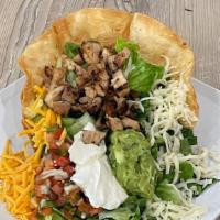 Taco Salad · With flour tortilla shell, romaine lettuce, beans, cheese, guacamole, sour cream, pico de ga...