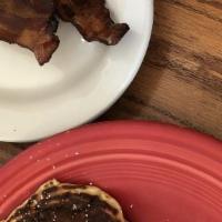 COMBO · Two buttermilk pancakes, two strips of bacon and one egg.