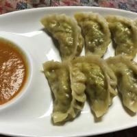 Veggie Mo Mo · Vegan. Steamed dumplings filled with mushroom, cabbage, turmeric powder, and spring onion. S...