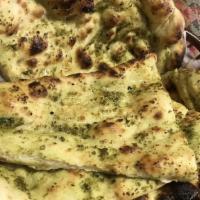 Basil Pesto Naan · Basil pesto brushed on flat bread and baked in oven.