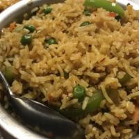 Vegetable Fried Rice · Basmati rice cooked with mixed vegetables, fried onions and garlic with Tibetan sauce.