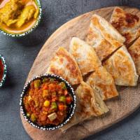 Palata · A flaky layered flatbread bread served with your choice of curry for dipping.