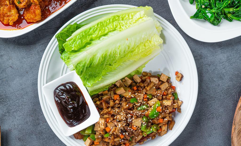 Lettuce Wrap · Romaine lettuce with carrots, green bell peppers, mushrooms, radish, ginger, garlic, water chestnuts, sesame seeds and hoisin sauce. 
Gluten-free option available.