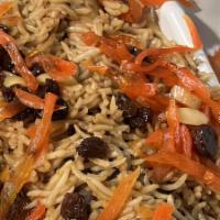 Quabili Pallow · Afghanistan's most popular dish, brown basmati rice with lamb shank, topped with sautéed rai...
