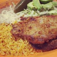 Milanesa Plate · Breaded steak or chicken served with rice, beans, and french fries.