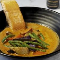 Spicy Coconut Broth Fish · Breaded fish infused with eggplant and string beans in our house spicy coconut sauce.