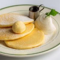 Classic Pancakes  · A classic set of pancakes, topped with whipped cream and butter served with syrup.