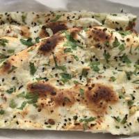 Garlic Naan · Garlic, cilantro and onion seeds topped and leavened flatbread.
