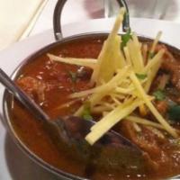 Chicken Curry · Authentic North Indian chicken specialty onions, tomatoes and spices.