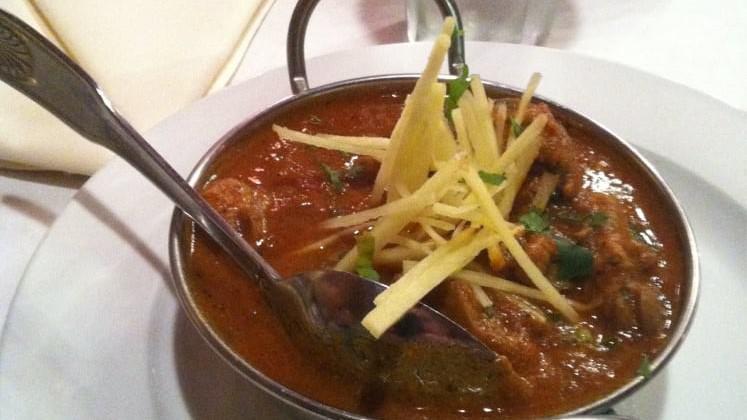 Chicken Curry · Authentic North Indian chicken specialty onions, tomatoes and spices.