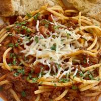 Pasta Bolognese · Home-made beef bolognese sauce, spaghetti, parmesan, and toast.