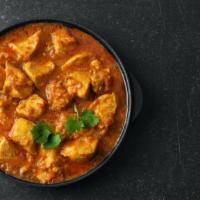 Chicken Curry · Marinated boneless chicken in chef's onion based curry and topped with spices.