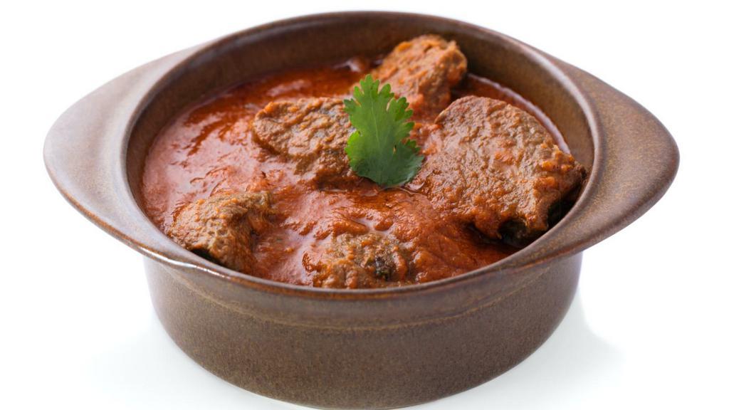 Lamb Curry · Marinated lamb pieces in chef's tomato and onion based curry and topped with spices.