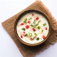 Raita · Yogurt with grated cucumbers, carrots, and spices.