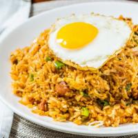 Kimchi Fried Rice · A Korean inspired fried rice sautéed with spicy kimchi, green onions and spam. Topped with c...