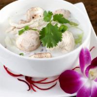 Tom Kha · Coconut milk soup with lemongrass, galangal, kaffir lime leaves and mushrooms topped with ci...