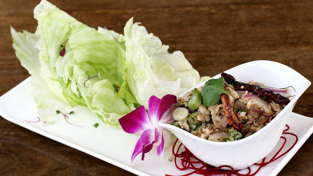 Lettuce Wrap · Gluten-free. Minced chicken, red and green onions, cilantros, lemongrass, mint, lava sauce with lettuce leaves.