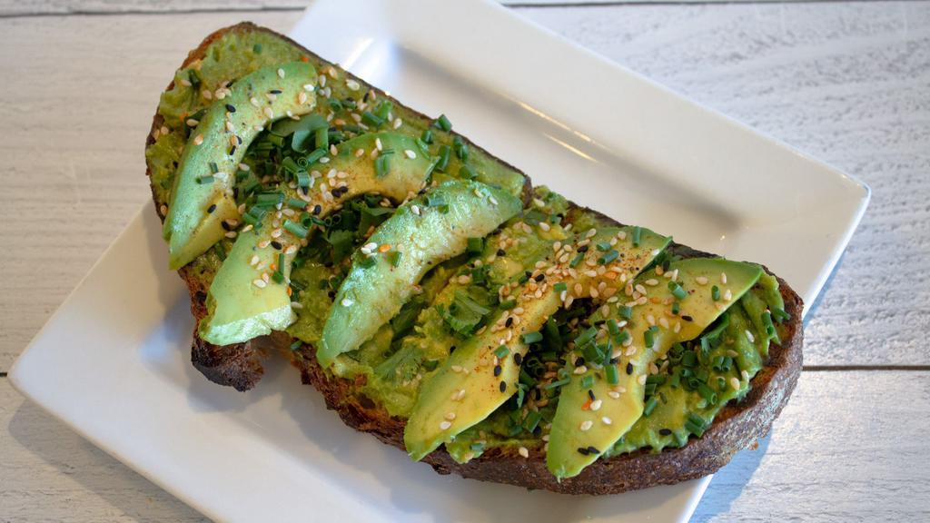 Avocado Toast · A thick slice of toasted Rustic Bakery Campagne bread, topped with freshly mashed avocado, cilantro, chives, and toasted seeds.