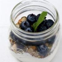 Greek Yogurt · Straus Organic Greek Yogurt, topped with seeds and a drizzle of agave syrup, blueberries, an...