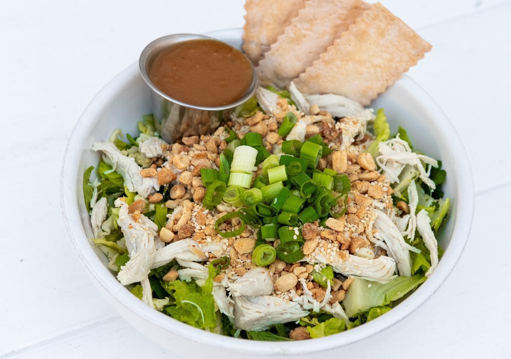 Asian Chicken Salad · Sliced romaine, Savoy cabbage with mint, cilantro, scallions, roast chicken, sesame seeds, ground peanuts, served with a peanut dressing.