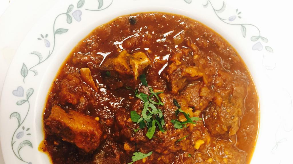 Goat Masala (No Rice) · 16 oz bowl cooked Goat bone in or bone less meat ,onion ginger, garlic and own spices, tomato paste, and gravy