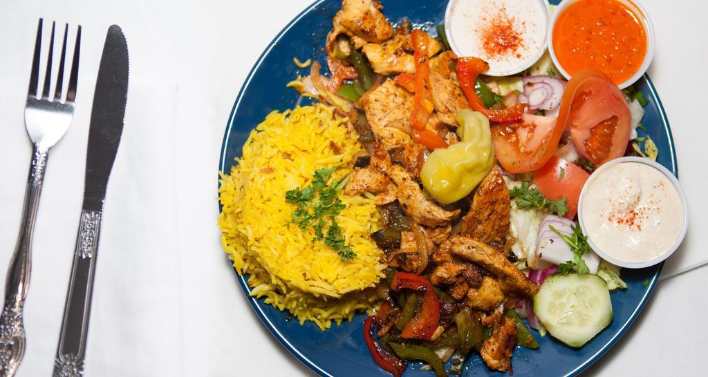 Chicken Shawarma Plate · Chicken served with rice, hummus, green salad, and pocket bread.