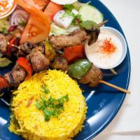 Lamb Shish Kebab Plate · Lamb served with rice, hummus, green salad, and pocket bread.