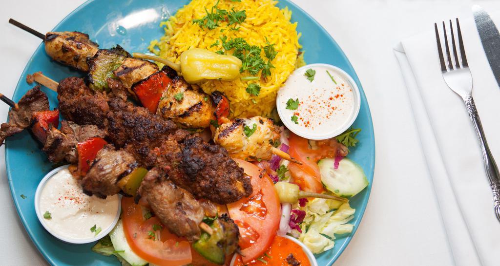 Mixed Grill Plate · Mixed grill consists of chicken and lamb shish kebab, kofte kebab, served with rice, green salad, hummus, and pocket bread.
