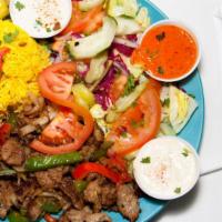 Beef Shawarma Plate · Beef, served with rice, hummus, green salad, and pocket bread.