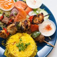 Combo Shish Kebab Plate · Chicken and lamb, served with rice, hummus, green salad, and pocket bread.