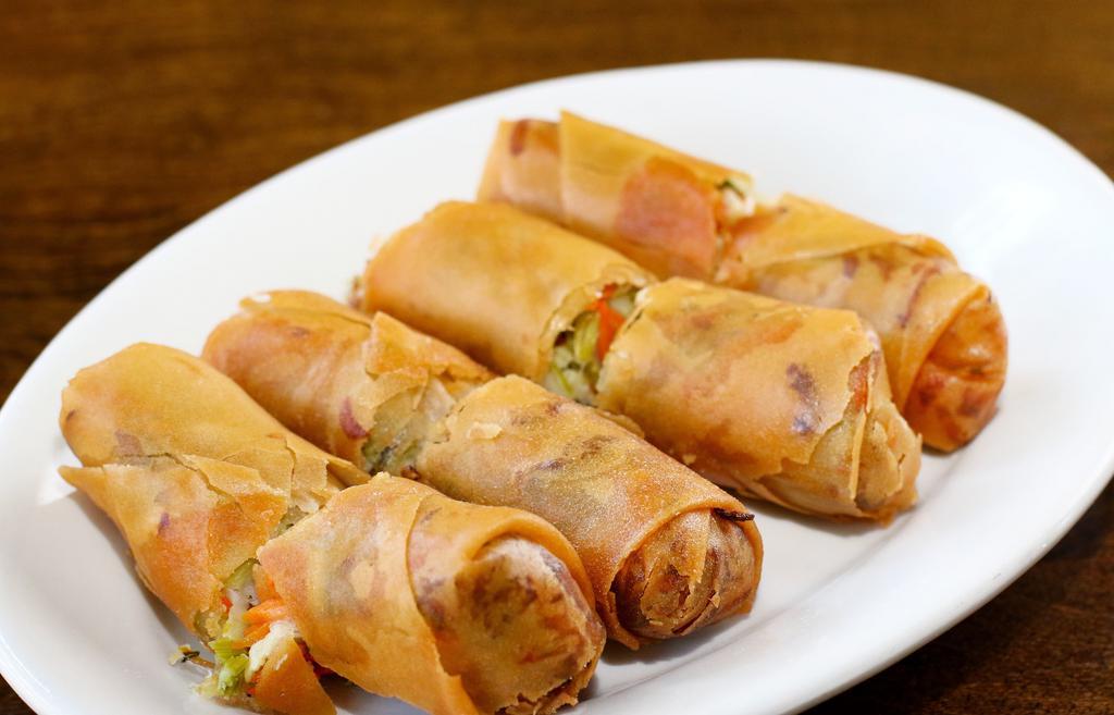Spring Rolls · Fresh shredded cabbage, celery, carrots, and onions in a thin crépe deep fried to golden brown.
