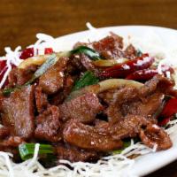 Mongolian Beef · Sliced beef sauteed with green onions and roasted red hot peppers in house sauce served on c...