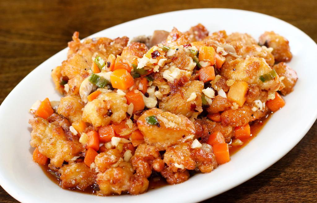 Spicy Dried Fried Chicken · Deep fried chicken chunks tossed with carrots, mushrooms, chili oil, minced ginger, ginger and green onions. Spicy.