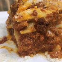 Lasagna alla Bolognese · Handmade lasagna pasta, traditional bolognese sauce, béchamel, mozzarella