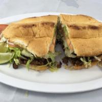 Torta · Meat, topped re-fried pinto beans mayonnaise, cheese, sour cream, lettuce, tomato and avocado.