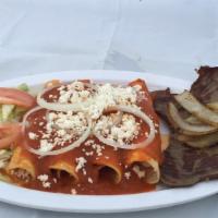 Entomatadas · Rolled-up corn tortilla dipped in tomato sauce filled with cheese, served with tasajo (thinl...