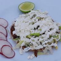 Sopes (Each) · Handmade thick tortilla, topped re-fried pinto beans, meat, lettuce, sour cream, and cheese.