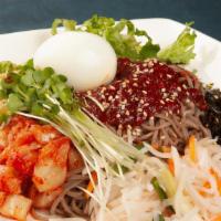 21. Bibim Mak Guk Soo · Korean cold buckwheat noodles with kimchi, lettuce, radish, boiled egg, and seaweed served i...