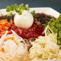 Makguksoo · Korean cold buckwheat noodles with kimchi, lettuce, radish, boiled egg, and seaweed served i...