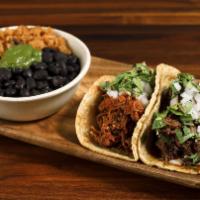 Combo · Choice of 2 tacos + rice-o-licious + vegan refried beans. Comes with three signature salsas.