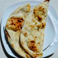 Plain Naan · Unleavened white flour breads baked in charcoal fired clay oven.