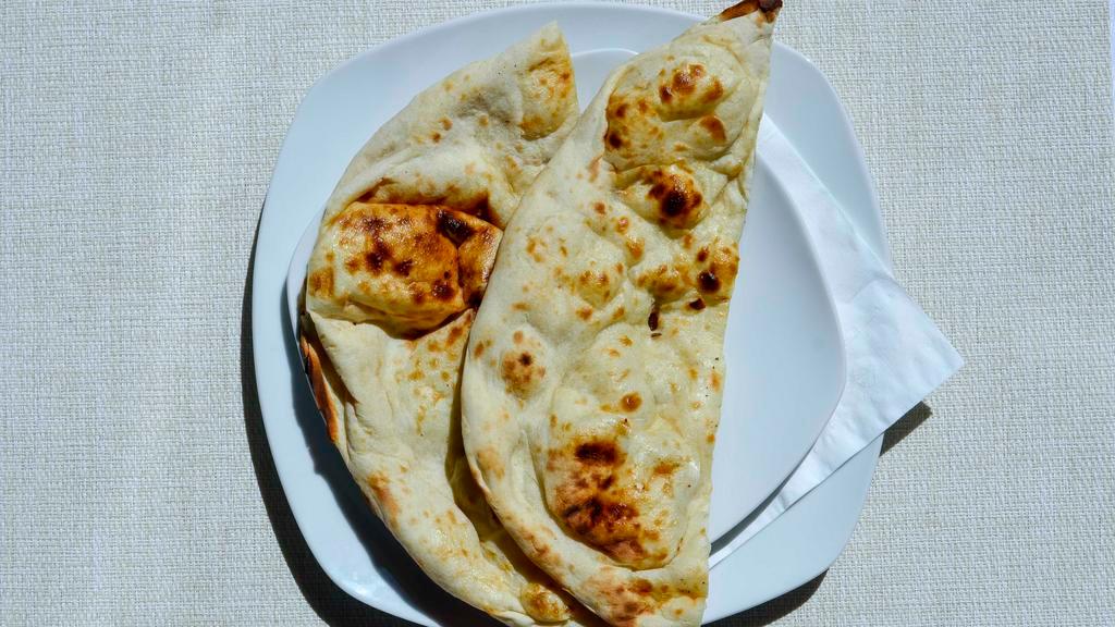Plain Naan · Unleavened white flour breads baked in charcoal fired clay oven.