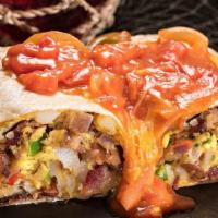 Huck'S Breakfast Burrito · Your choice of grilled ham, Sausage, bacon or andouille Sausage tossed with bell peppers, on...