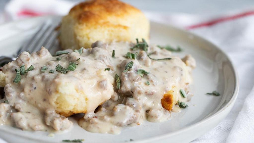 Biscuits & Gravy · Our scratch-made buttermilk biscuit topped with Huck's country gravy.  Your choice of 2 bacon, sausage OR ham. Served with Country Reds.