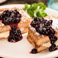 Stuffed French Toast · Two slices of thick new Orleans sourdough, egg dipped and golden grilled then stuffed with s...