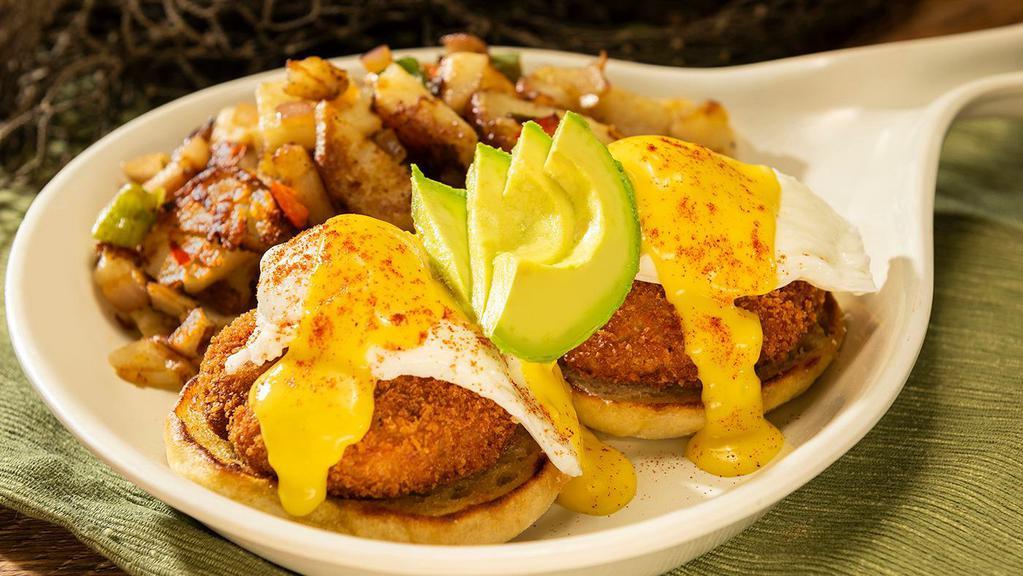 Crab Cake Benedict · Two poached eggs over tender crab cakes on an English muffin with Hollandaise sauce and fresh avocado.