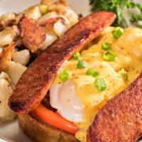 Cajun Benedict · Two poached eggs over grilled andouille sausage, sliced tomatoes and our toasted sourdough t...