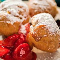 Mardi Gras Beignets · Our signature southern fritters atop sweet, vanilla cream filling with huckleberry. strawber...