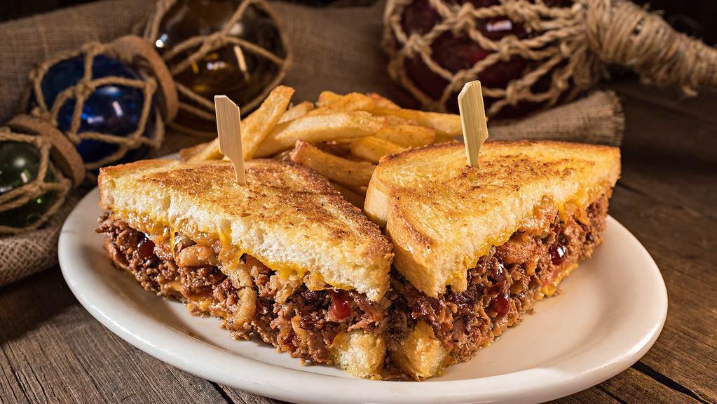 Dixieland Steak Melt · Thinly sliced sirloin drizzled with Huck's BBQ sauce on grilled sourdough topped with Onion Tanglers, fresh tomatoes and cheddar cheese.
