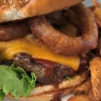 Road House Burger · Beef Patty, Cheddar Cheese, Bacon, Onion, Rings, BBQ Sauce and Lettuce on a Sesame Bun.